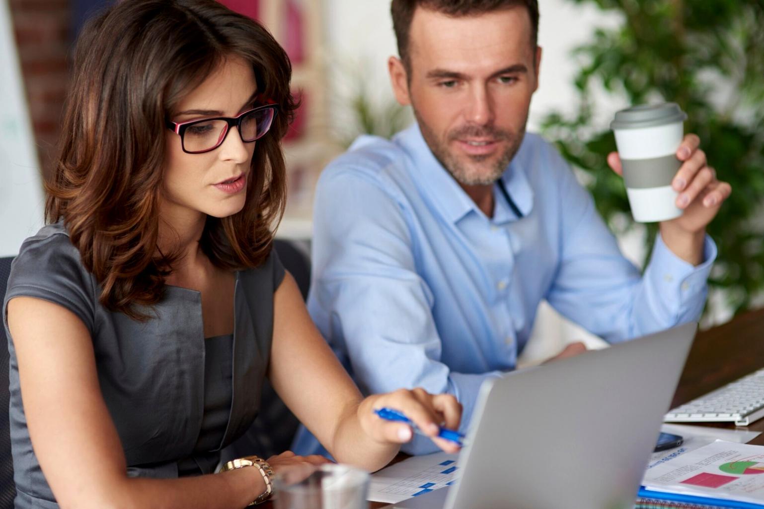 Students collaborating on investment analysis in modern learning environment